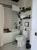 a bathroom with a toilet and bathtub