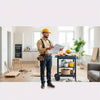 Contractor reviewing remodeling plans in a bright home with neatly organized tools in the background