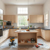 Modern kitchen during a renovation with new cabinetry, an island, and clean countertops in bright daylight
