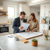 Contractor and homeowner review remodeling plans in a bright kitchen during a consultation