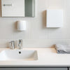 Modern bathroom fixtures arranged on a clean countertop with matching faucet and shower hardware
