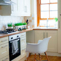 white chair near kitchen oven during daytime