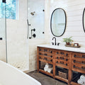 white ceramic bathtub near brown wooden cabinet