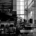 grayscale photo of empty chairs and tables