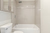 white ceramic bathtub near white ceramic bathtub