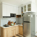 a kitchen with a silver refrigerator freezer next to a stove top oven