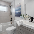 a bathroom with a toilet, sink, and bathtub