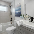 a bathroom with a toilet, sink, and bathtub