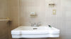 a white sink in a bathroom next to a toilet