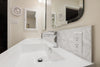 a bathroom with a sink and mirrors