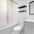 a bathroom with a tub toilet and sink