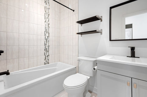a bathroom with a tub toilet and sink