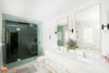 a bathroom with two sinks, a toilet and a shower