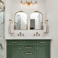 a bathroom with marble counter tops and green cabinets