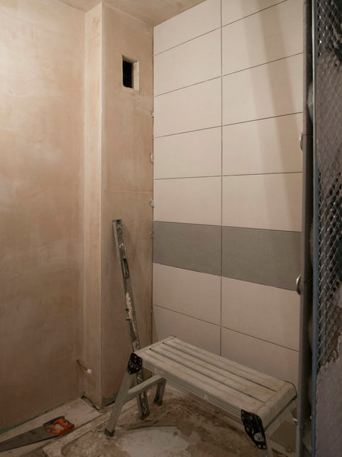 a bathroom with a bench and tiled walls