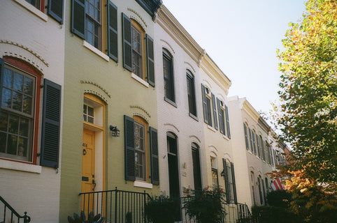 a row of houses with yellow doors and windows