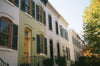 a row of houses with yellow doors and windows