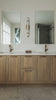 a bathroom with two sinks and a large mirror