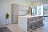 a kitchen with a center island with four stools