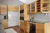 A kitchen with wooden cabinets and white appliances