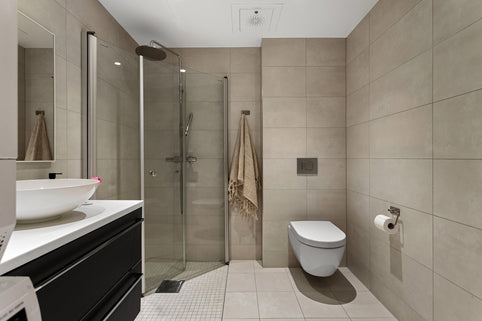 A bathroom with a toilet, sink, and shower