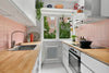 A kitchen with a wooden counter top and white cabinets