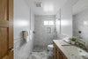 A bathroom with a sink, toilet, and shower
