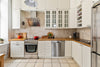 A kitchen with white cabinets and stainless steel appliances