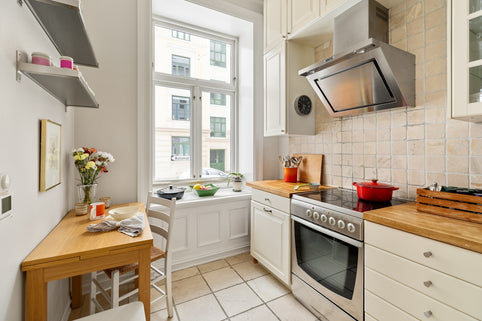A kitchen with a stove top oven next to a table