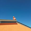A man standing on top of a roof