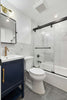 A bathroom with a toilet, sink, and shower