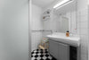 A bathroom with a checkered floor and white walls