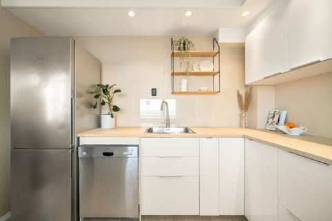 A kitchen with a refrigerator and a sink