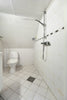 A bathroom with a toilet, sink, and shower
