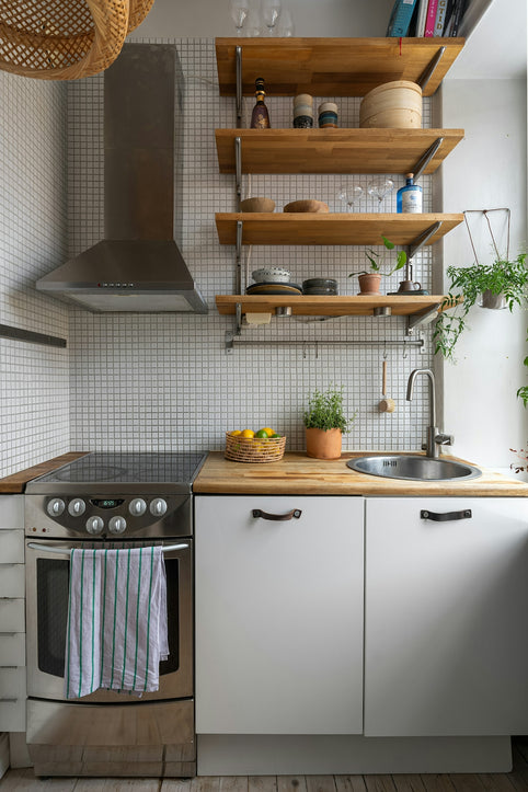 A kitchen with a stove top oven next to a sink