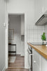 A white kitchen with a wooden counter top