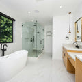 A large white bathroom with a large tub