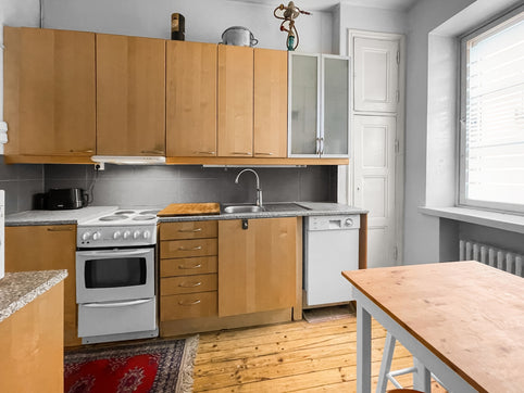 A kitchen with a table and a stove top oven