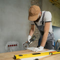 A man sanding a wooden table with a sander