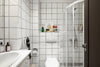 A bathroom with a toilet, sink, and shower