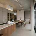 Modern kitchen and dining area with concrete ceiling