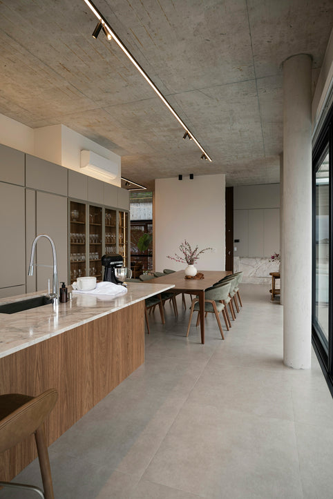 Modern kitchen and dining area with concrete ceiling