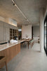 Modern kitchen and dining area with concrete ceiling