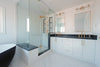 Modern bathroom with a freestanding tub and glass shower.
