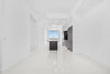Modern apartment hallway with kitchen island and cabinets