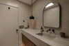 Modern bathroom with concrete sink and black faucet.