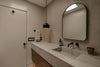 Modern bathroom with concrete sink and black faucet.