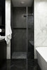 Modern bathroom with marble and dark stone shower.
