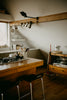 Modern kitchen island with stools and cooking utensils.