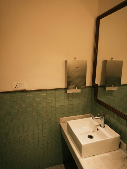 Modern bathroom sink with tiled wall and mirror